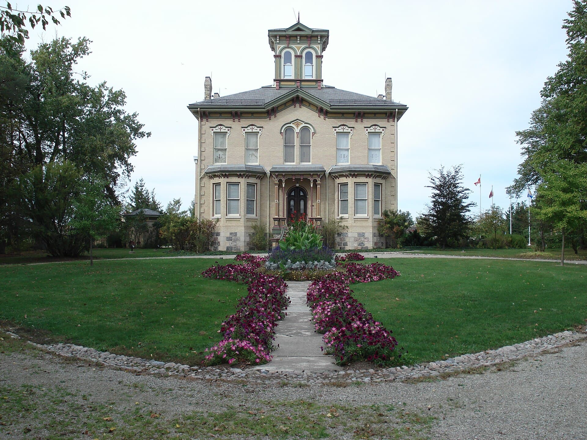 Castle Kilbride in Baden, its tower rising over the front lawn and flower beds