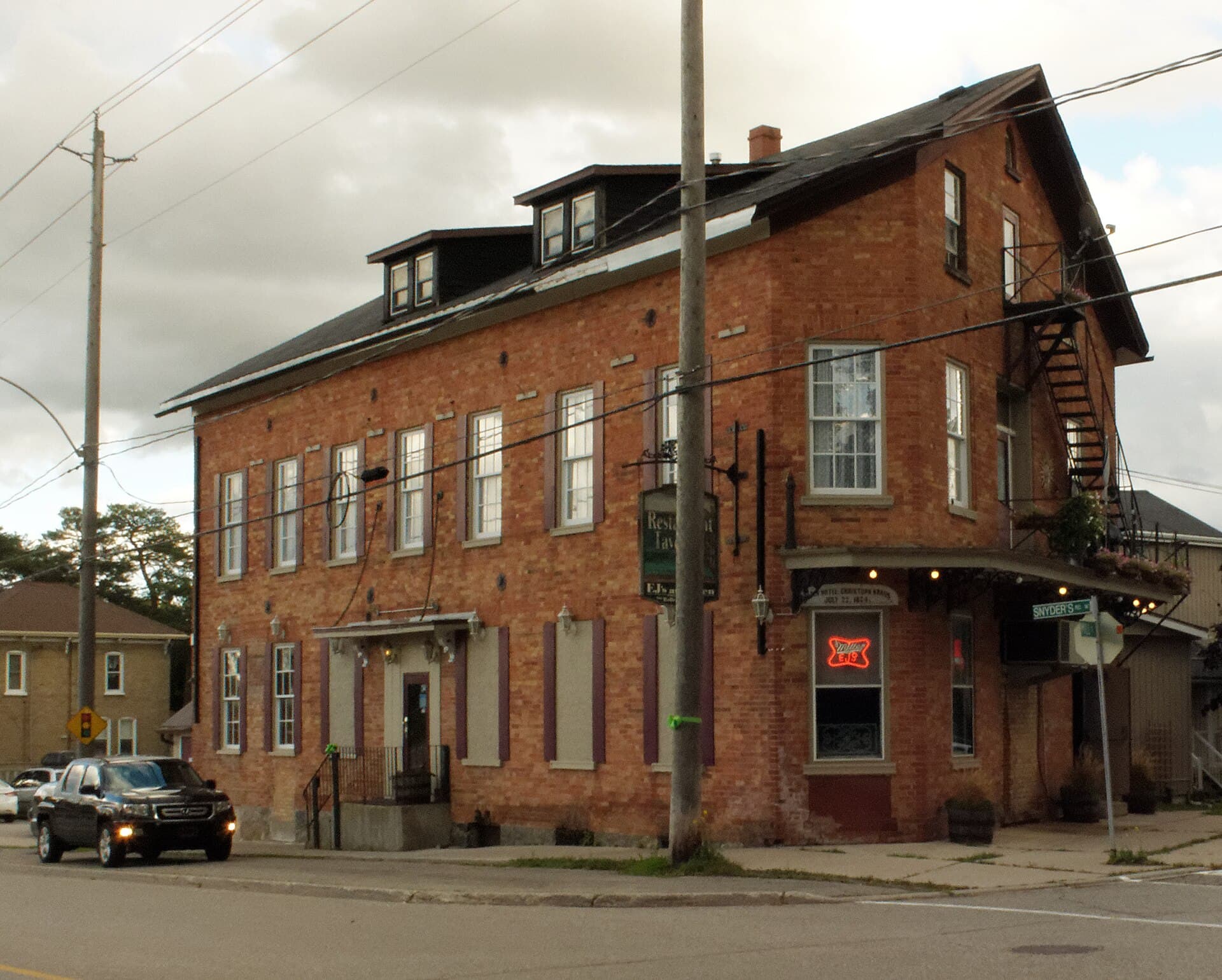 EJ's Tavern on its Snyder's Road corner in Baden — the red-brick 1874 Baden Hotel